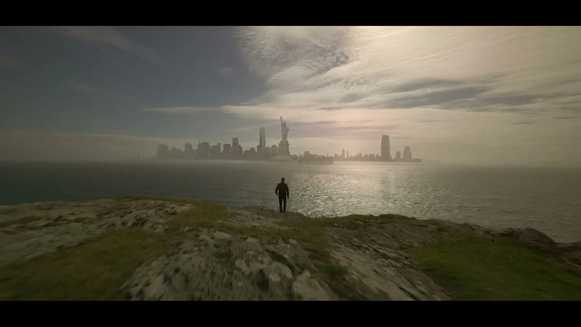 A man stands on a grassy cliff overlooking a vast ocean with a futuristic city skyline and the Statue of Liberty in the distance under a cloudy sky.