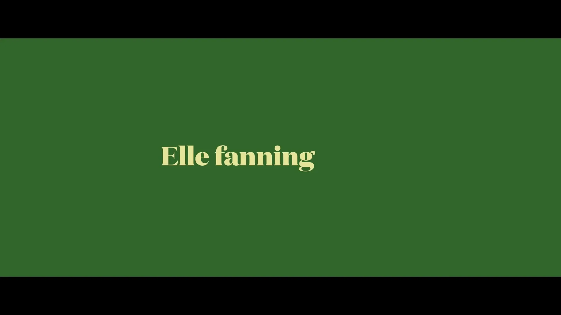 The words "Elle Fanning a rock" appear in a yellow serif font on a solid dark green background.