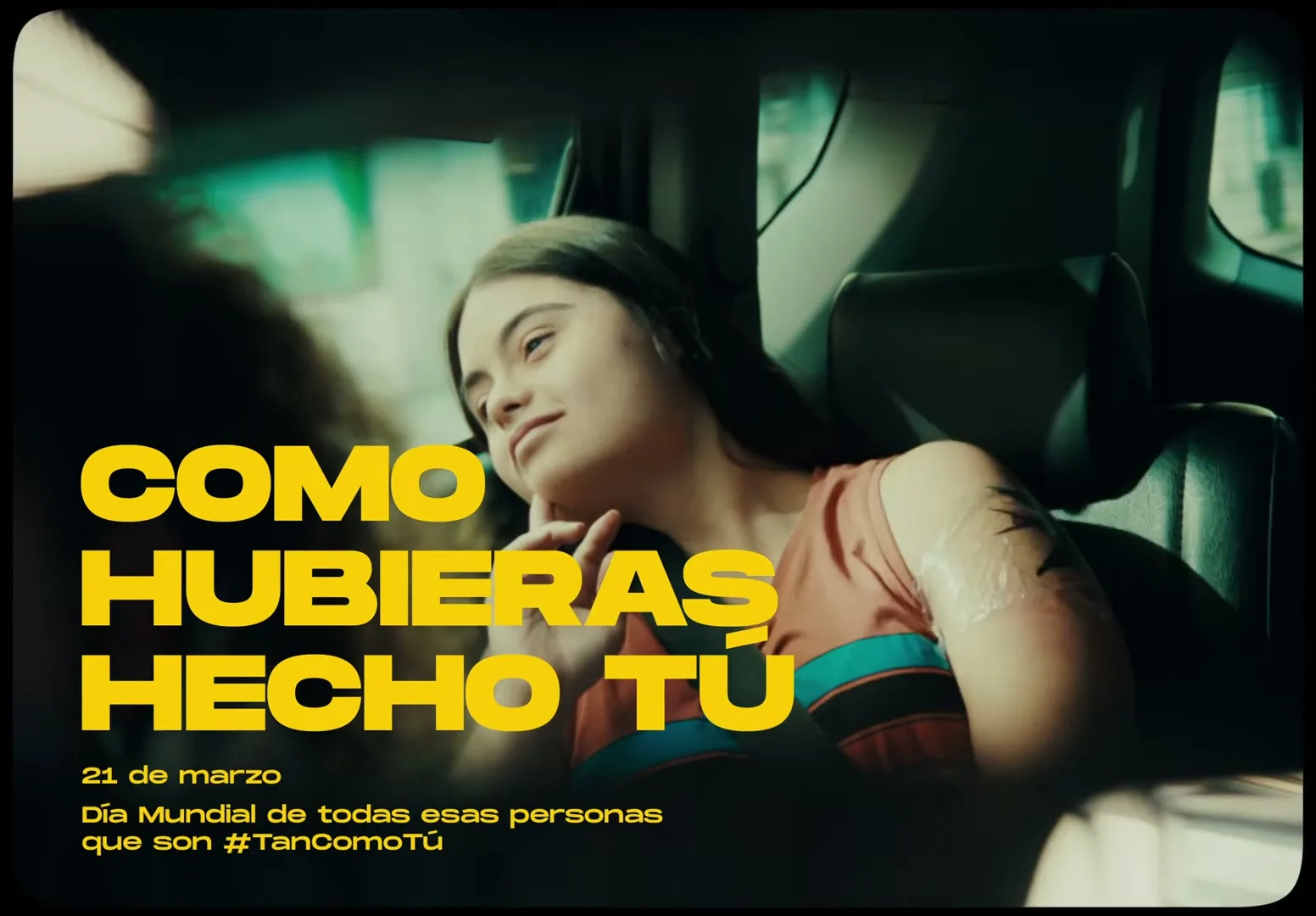 A young woman with long dark hair and a bandage on her arm sits in the back seat of a car, looking out the window with a thoughtful expression.