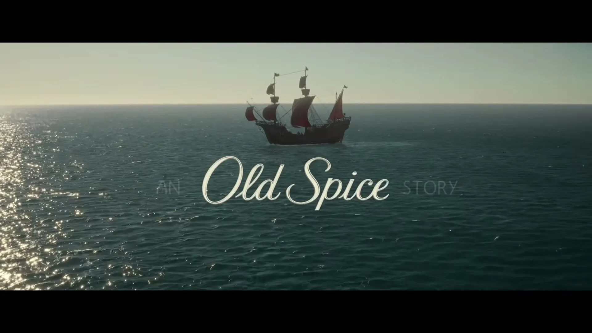 A pirate ship with red sails sails across a vast, calm ocean under a bright sky, with text overlayed on the water.