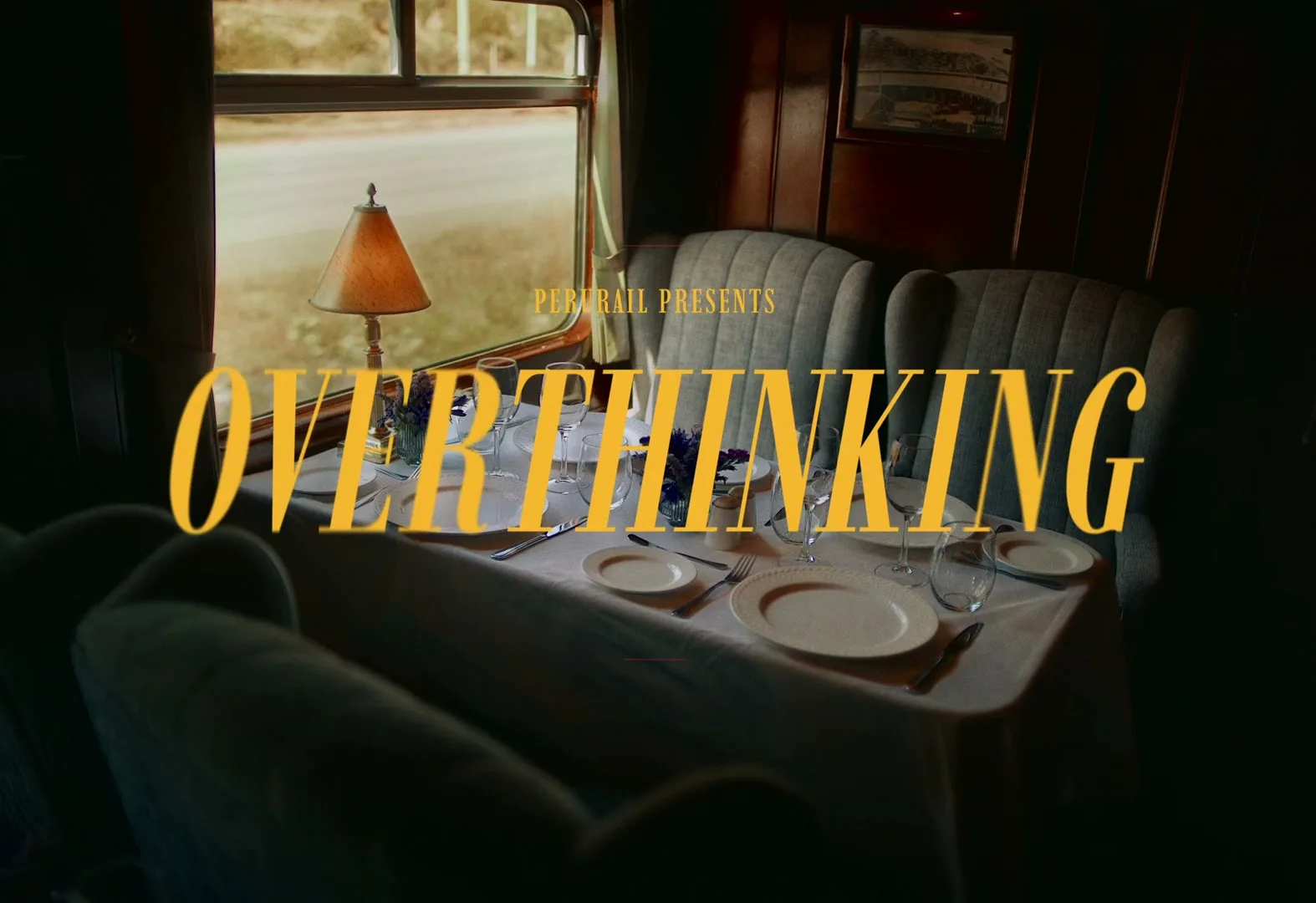 A title card with "PERURAIL PRESENTS OVERTHINKING" in yellow text overlays a shot of an empty dining table inside a moving train.