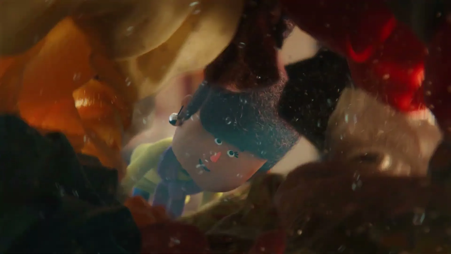 A stylized animated character with blue hair and a pink nose is seen through water bubbles, surrounded by colorful clothes in a washing machine.