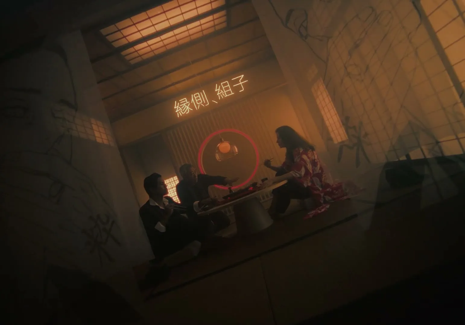 Three people sit around a low table in a dimly lit room with Japanese-style screens and neon text, as a red circle highlights a small object.