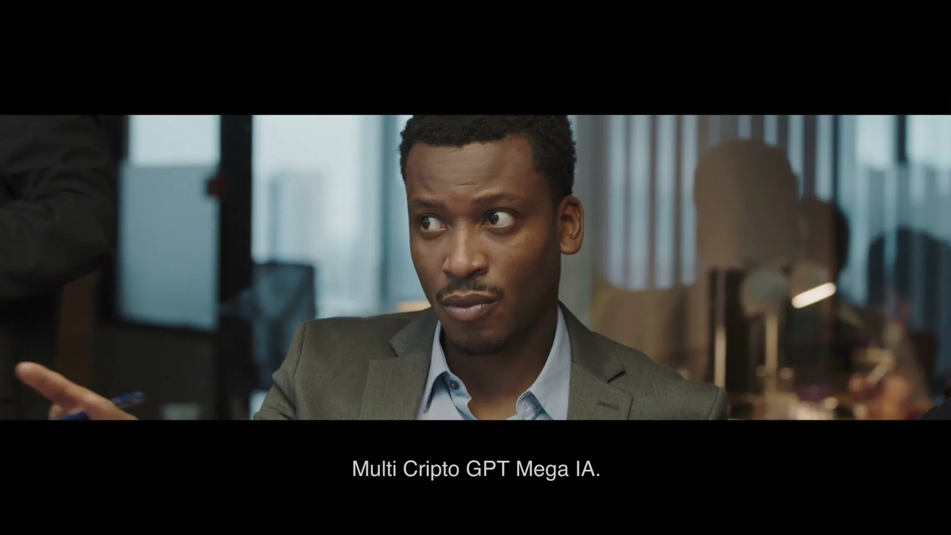 A Black man in his 30s, wearing a suit, looks to his right with a concerned expression in an office setting.