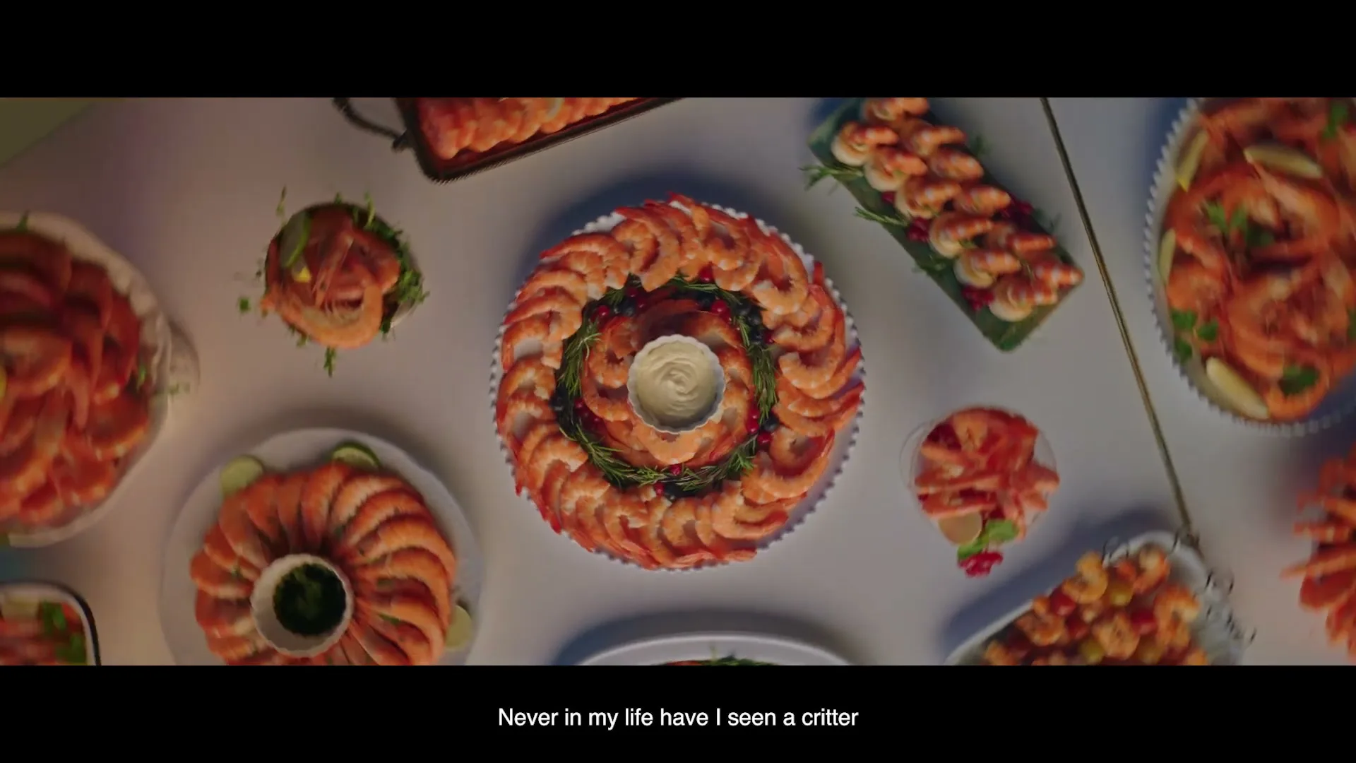 An overhead shot shows a table laden with various shrimp dishes, including a large circular platter with a dipping sauce in the center, surrounded by perfectly arranged shrimp.