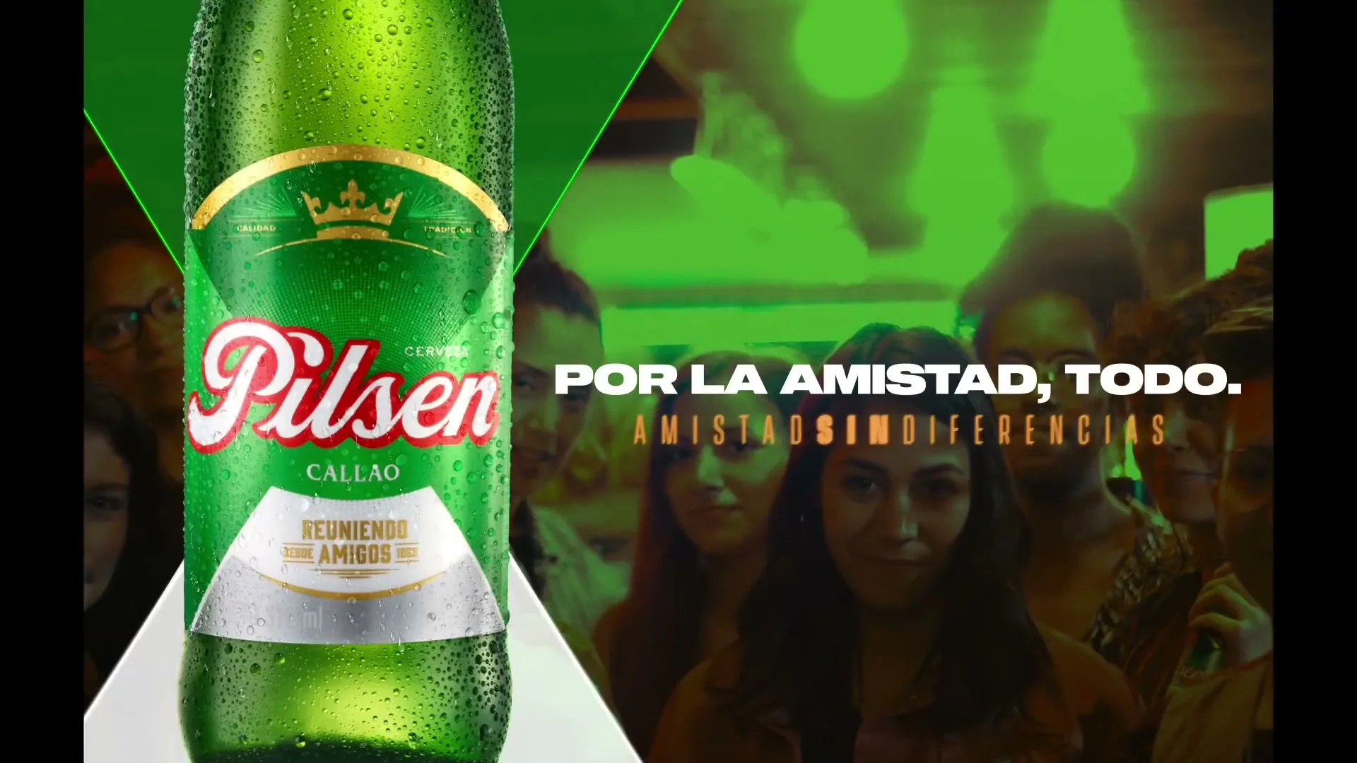 A diverse group of young adults stands together in a bar, smiling at the camera, with a Pilsen Callao beer bottle appearing in the foreground.
