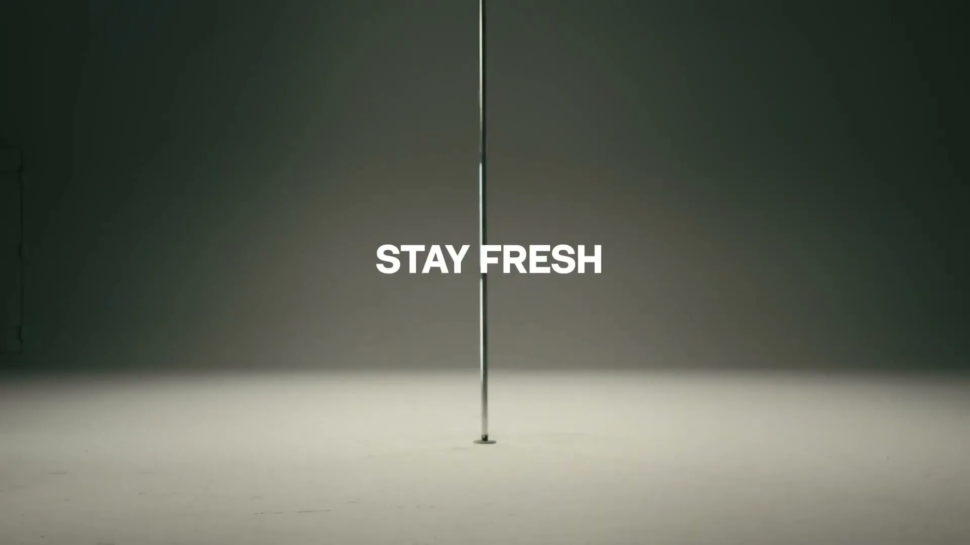 A shirtless man in black pants walks past a pole in a minimalist studio, then text appears, followed by the Sprite logo.
