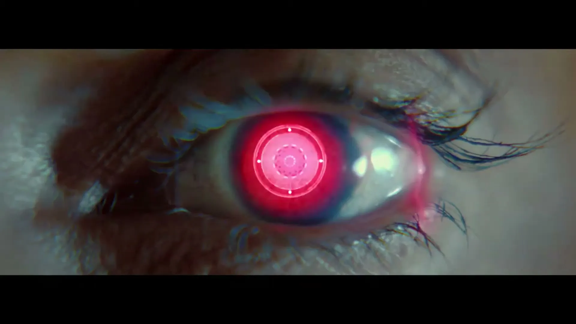 A woman's eye with a red digital target overlayed, suggesting a futuristic or sci-fi theme.
