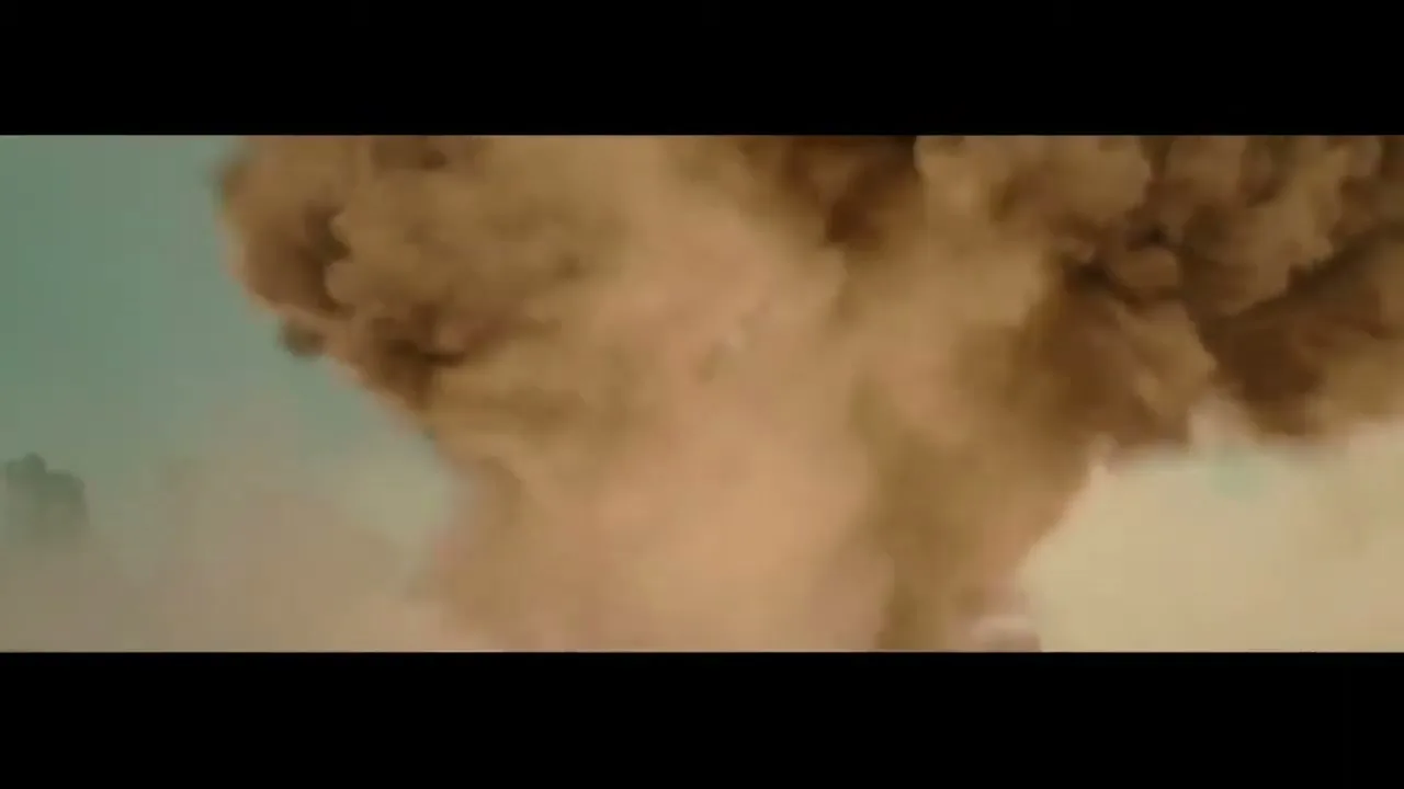 A massive explosion of brown dust and debris erupts upwards against a light blue sky, obscuring the view.