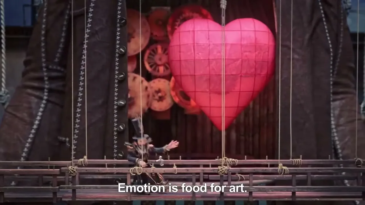 A small puppet-like figure in a top hat and dark clothes stands on a wooden platform, gesturing towards a large, glowing red heart with visible gears inside, set against a dark, textured background.