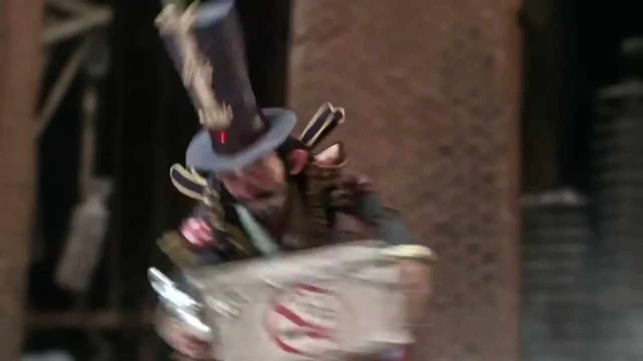 A stop-motion animated ringmaster-like character in a top hat and elaborate costume holds up a "no smoking" sign, then gestures with a wand.
