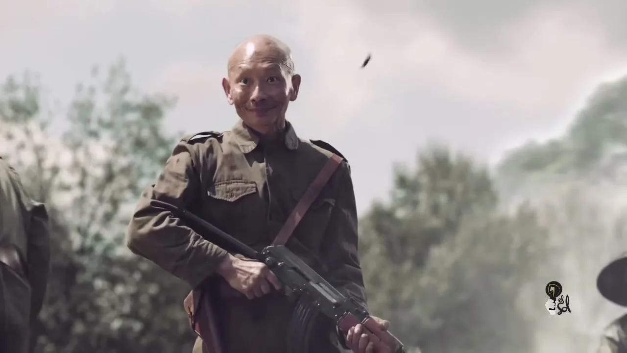 A bald Asian man in a military uniform holds a rifle and smiles, while another soldier walks past him in a war-torn landscape.