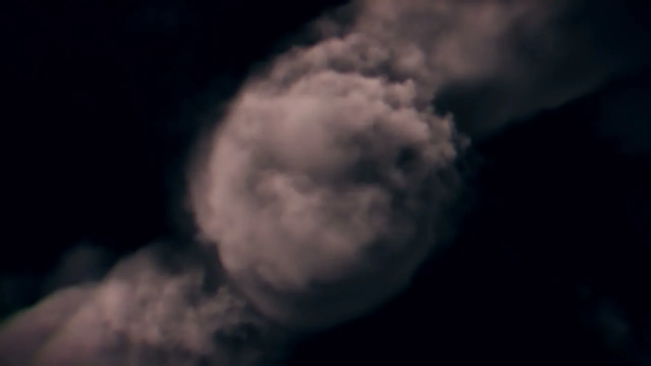 A dark background with smoke or clouds swirling and expanding, creating a dynamic and mysterious visual effect.