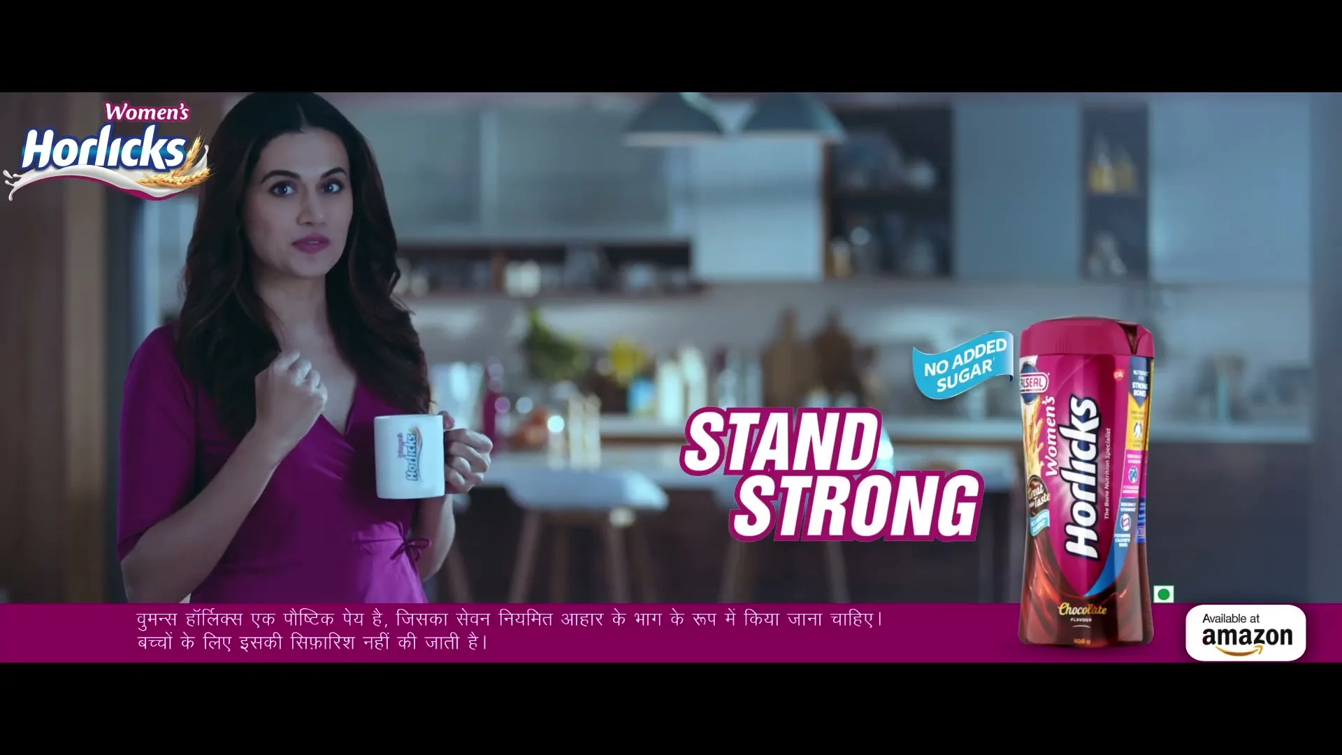 A woman in a purple dress holds a mug and smiles, standing in a modern kitchen with a Horlicks product and text overlay.