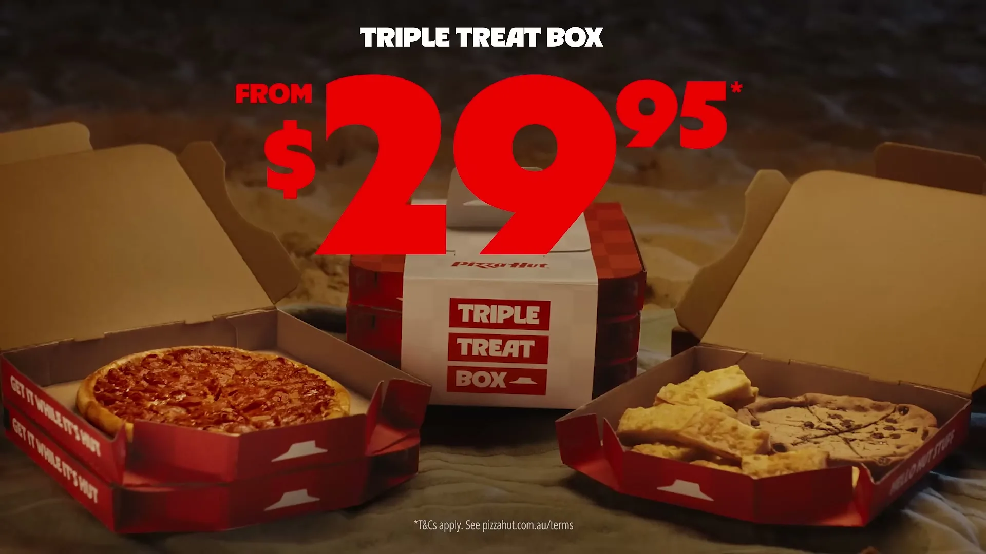 A Pizza Hut Triple Treat Box with two open boxes of pizza and dessert, and a closed box in the background, is shown with a price overlay.