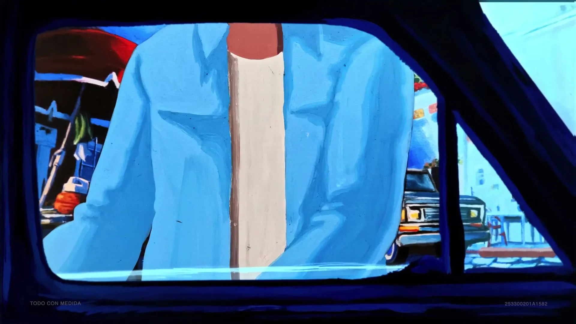 A person in a blue shirt and white t-shirt is seen through a car window, with a street scene visible outside.