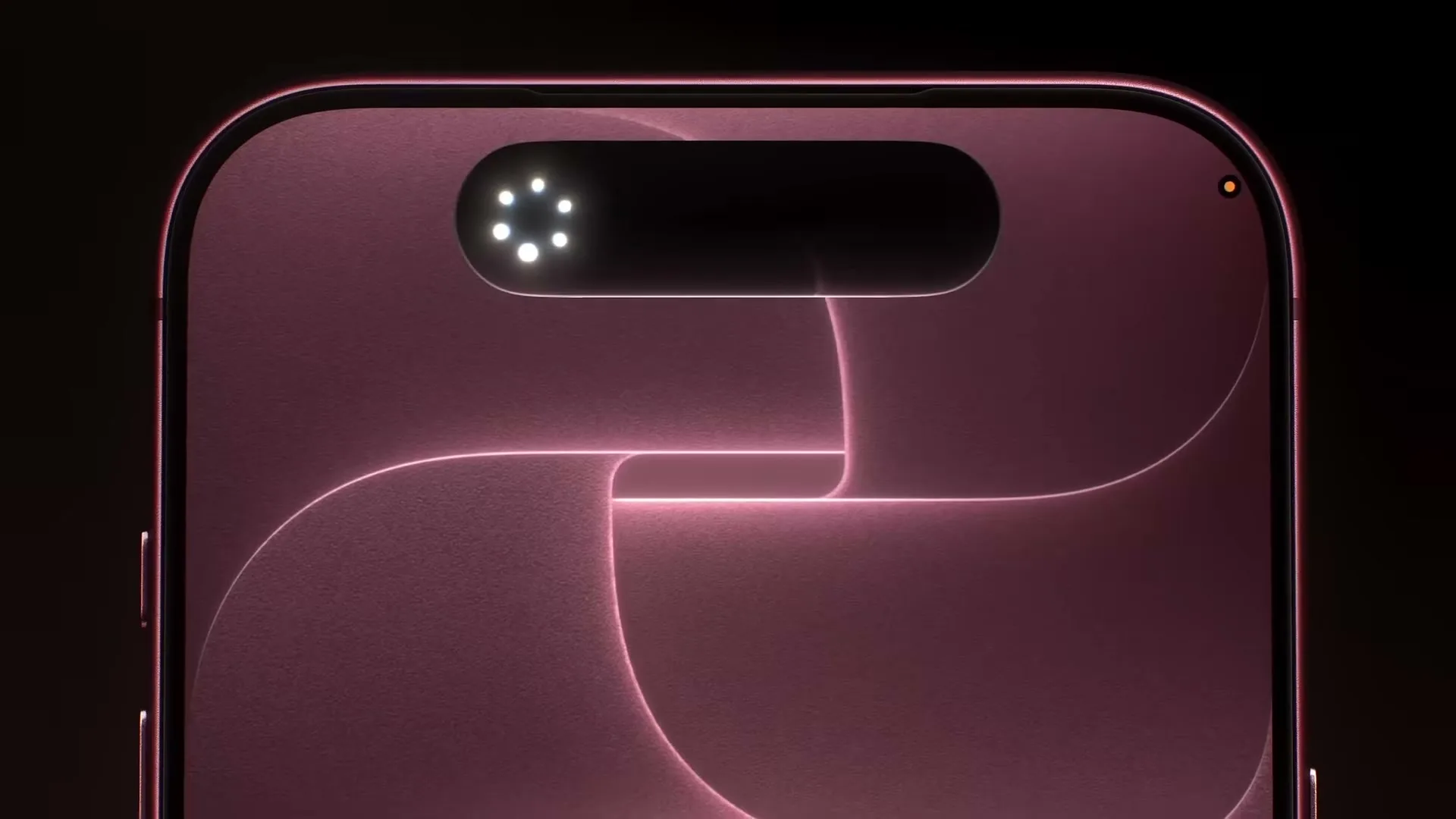 A close-up of the top of a pink smartphone screen shows a dynamic island expanding to reveal a notification.