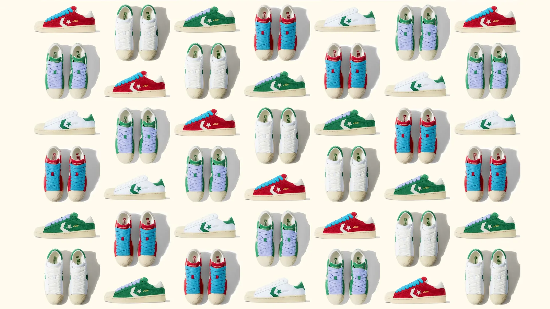 A grid of colorful Converse sneakers, some red, some green, some white, some blue, are neatly arranged on a light beige background.
