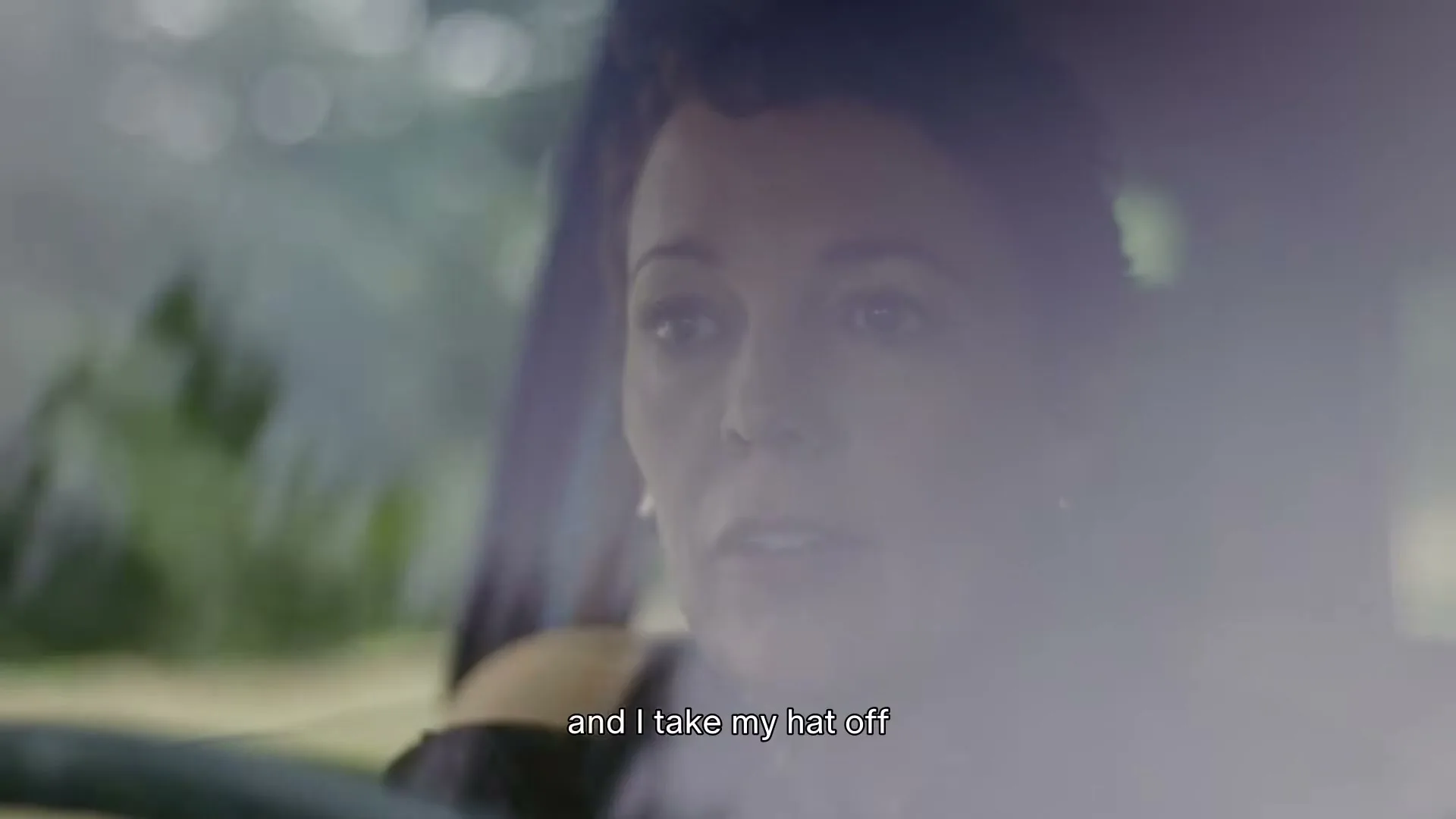 Olivia Colman, a woman in her 40s, is seen in a medium shot, looking out of a car window, talking about blackberries.