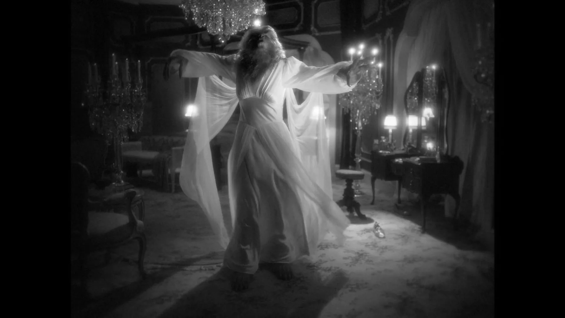 A female werewolf in a flowing white gown transforms and lunges towards the camera in a lavish, chandelier-filled room.