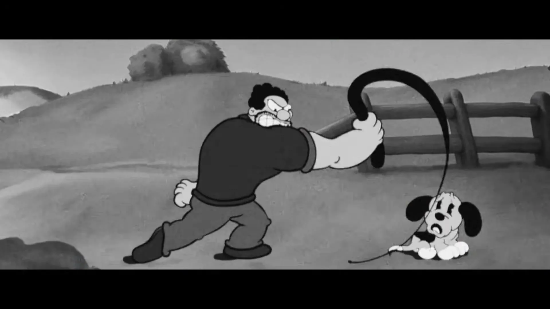A black and white animated man with a whip threatens a small, scared puppy in a rural outdoor setting.