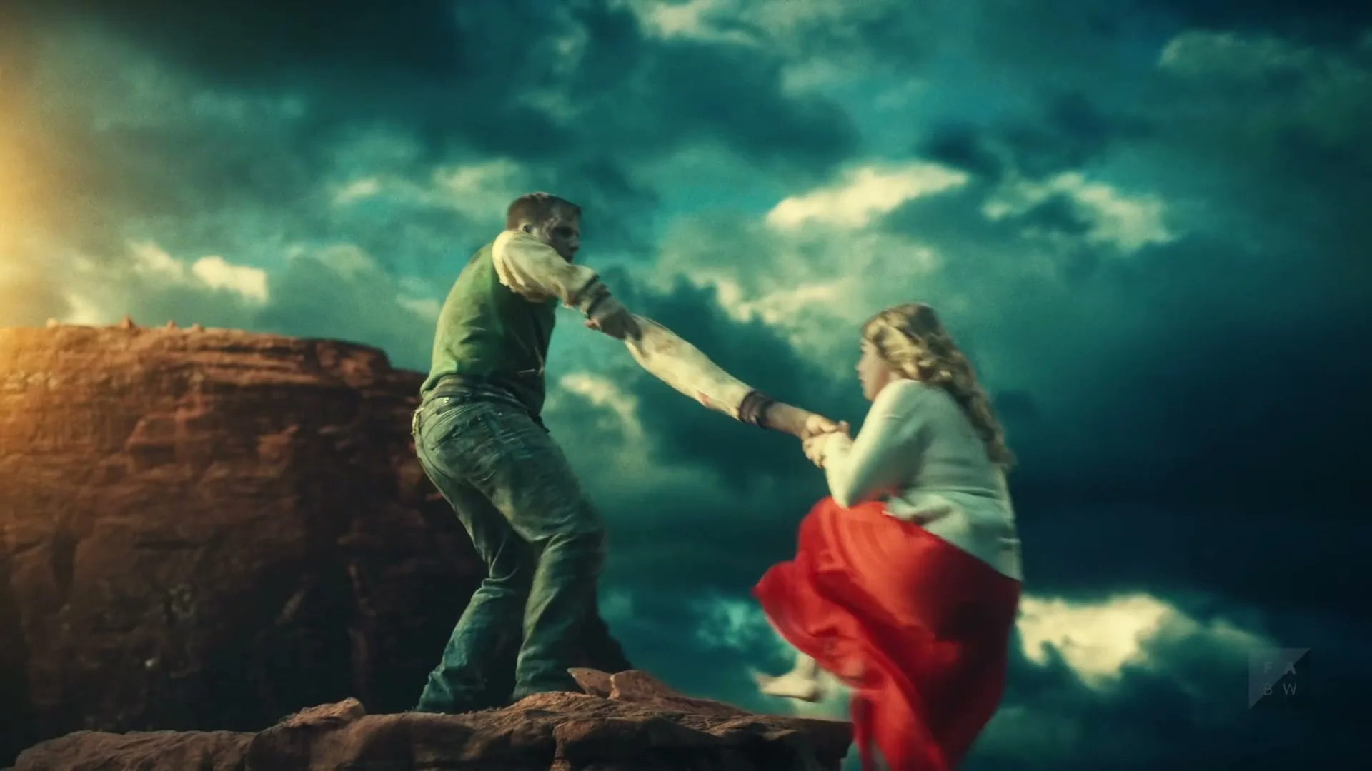 A zombie man in a green vest and jeans pulls a woman in a red skirt and white sweater up a rocky cliff under a dramatic sky.