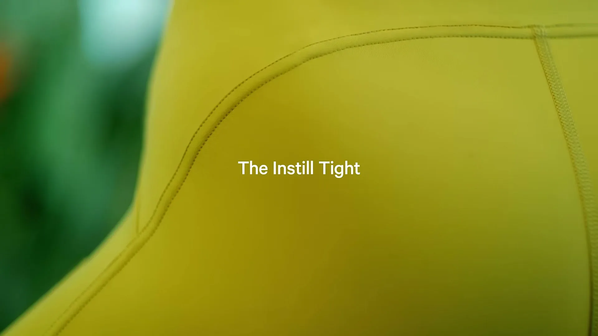 A closeup shot of yellow Lululemon leggings with the text "The Instill Tight" displayed on screen.
