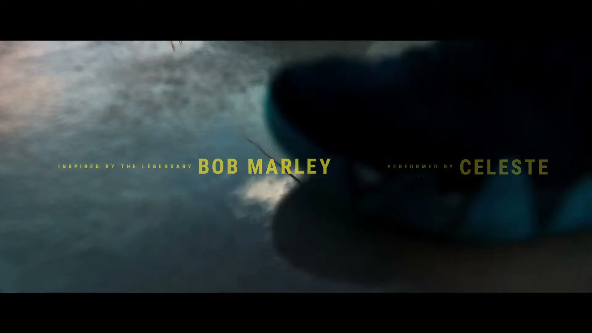Text "INSPIRED BY THE LEGENDARY BOB MARLEY" and "PERFORMED BY CELESTE" appears over a blurry, abstract background with a basketball hoop briefly visible.