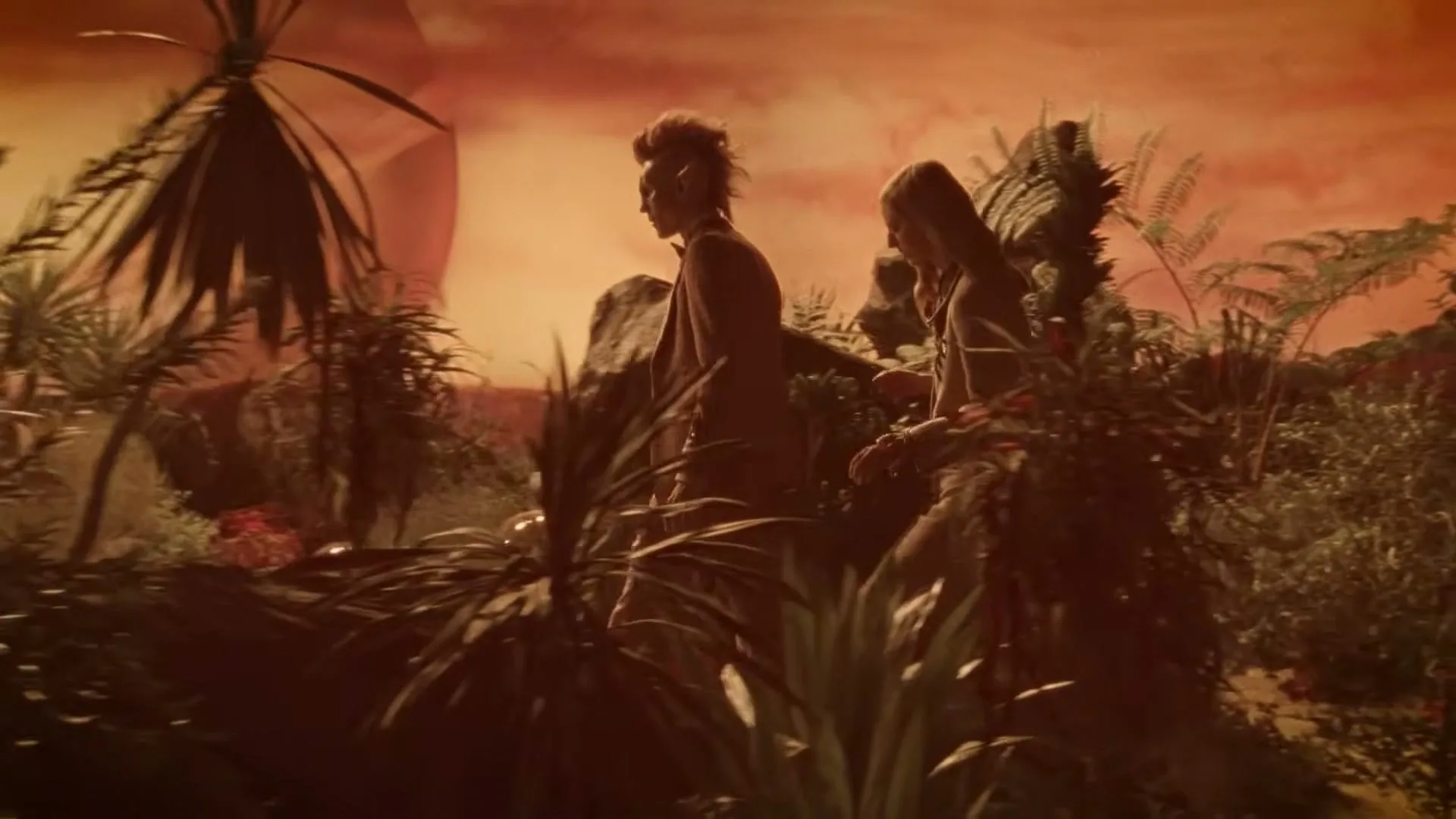 A man with a mohawk and a woman in a dress walk through a rocky, alien landscape with red skies.