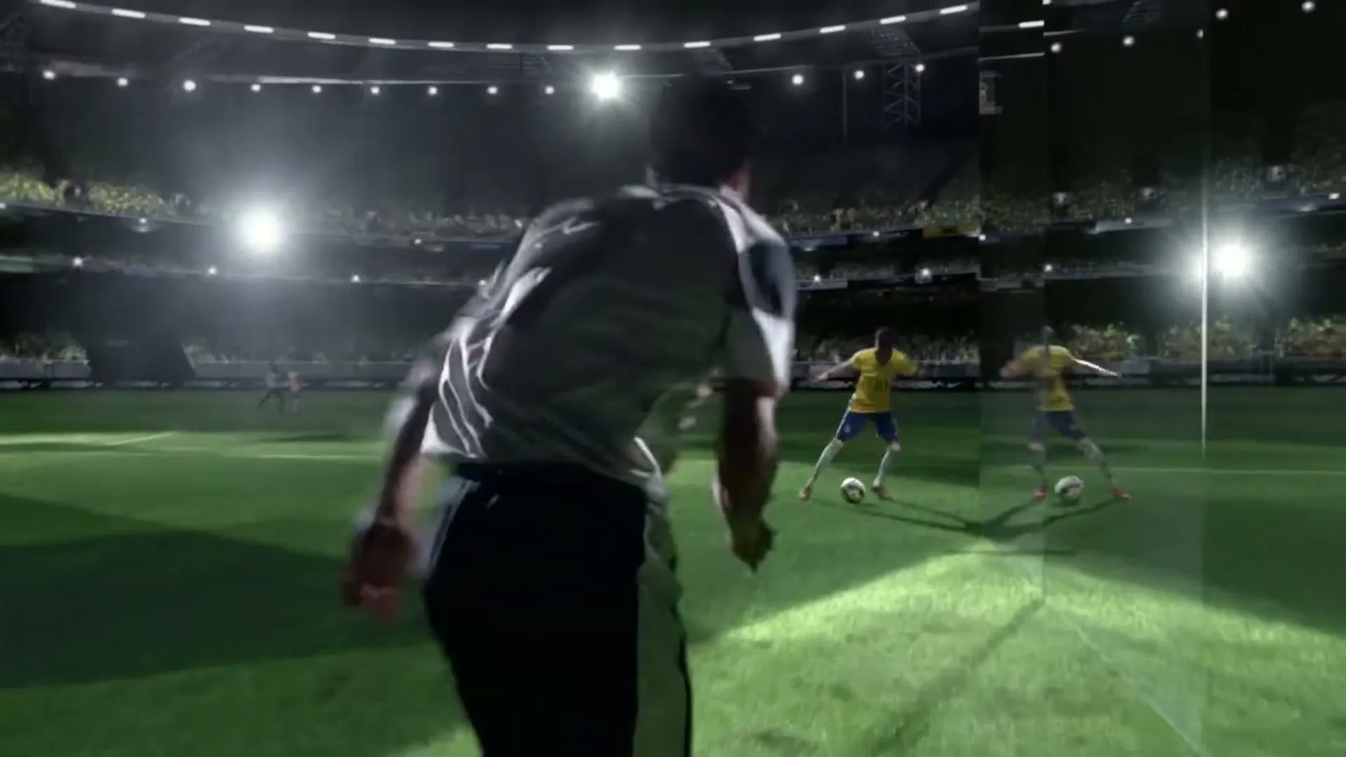 A soccer player in a white jersey runs towards the camera on a green field in a stadium at night, with two mirrored players in yellow jerseys in the background.