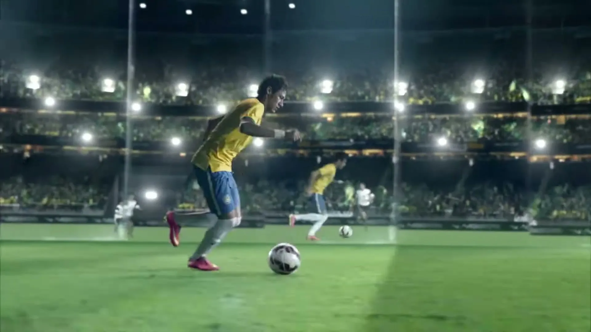 Neymar Jr. in a yellow and blue uniform dribbles a soccer ball past a sliding opponent in a brightly lit stadium.
