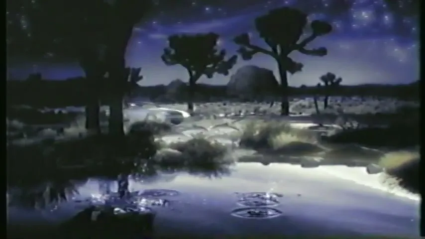 A white Mercedes-Benz car drives through a desert landscape at night, reflected in a still body of water under a starry sky.