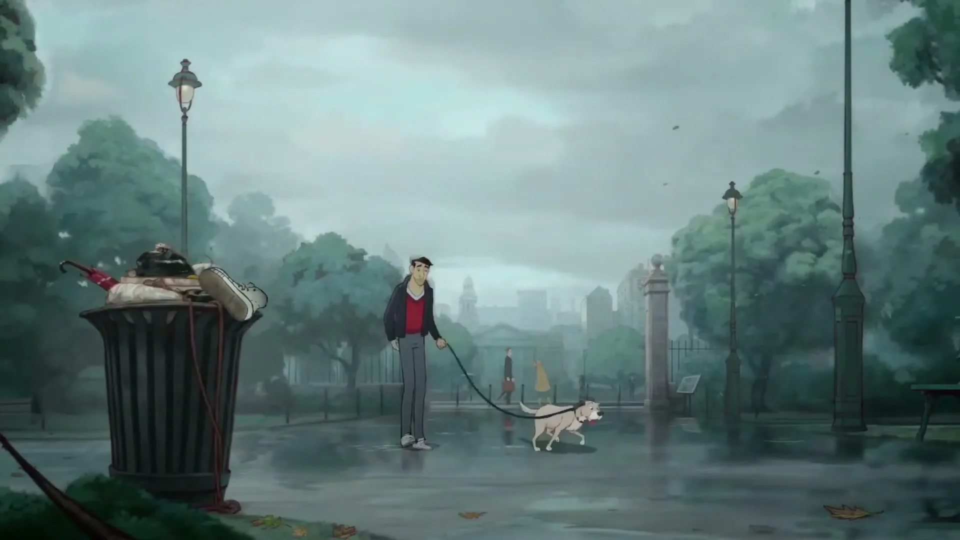 A man in a red shirt and grey pants walks his dog on a leash through a rainy park, with a trash can overflowing with items in the foreground.