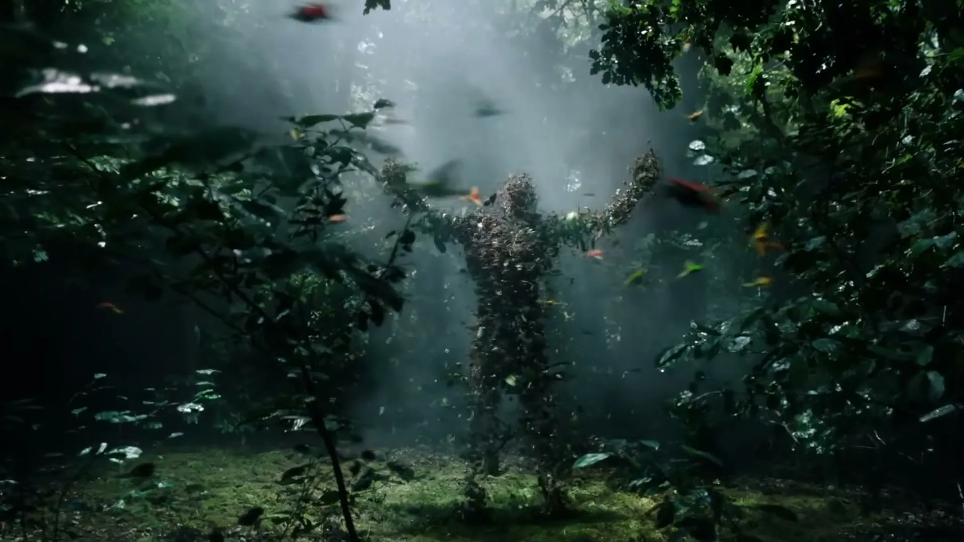 A human-shaped figure made of leaves stands in a misty forest, with colorful leaves and butterflies swirling around it.
