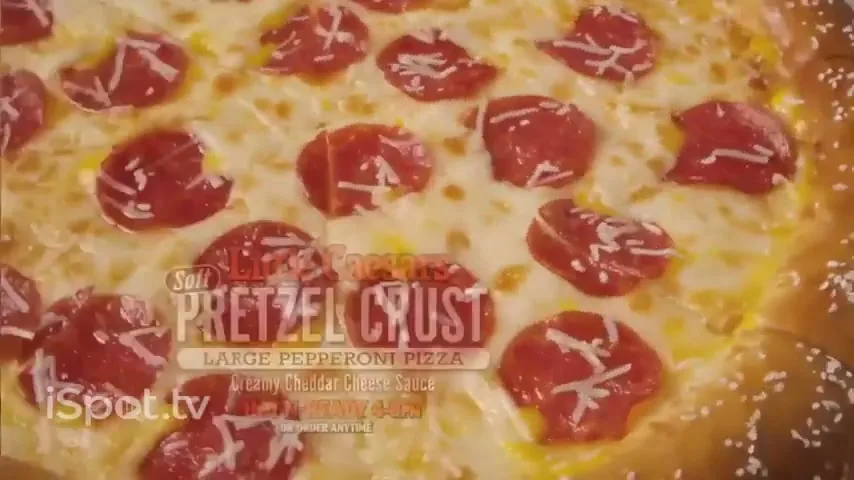 A delicious Little Caesars Hot-N-Ready Pretzel Crust Pizza with pepperoni and creamy cheddar cheese sauce is shown in a close-up shot.
