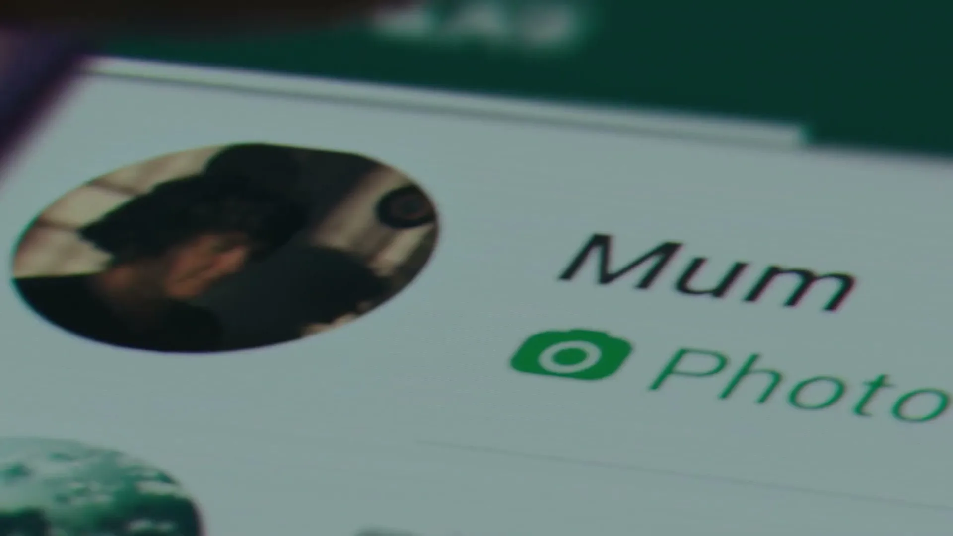 A close-up shot of a smartphone screen shows a WhatsApp chat with a contact named "Mum" and a profile picture.