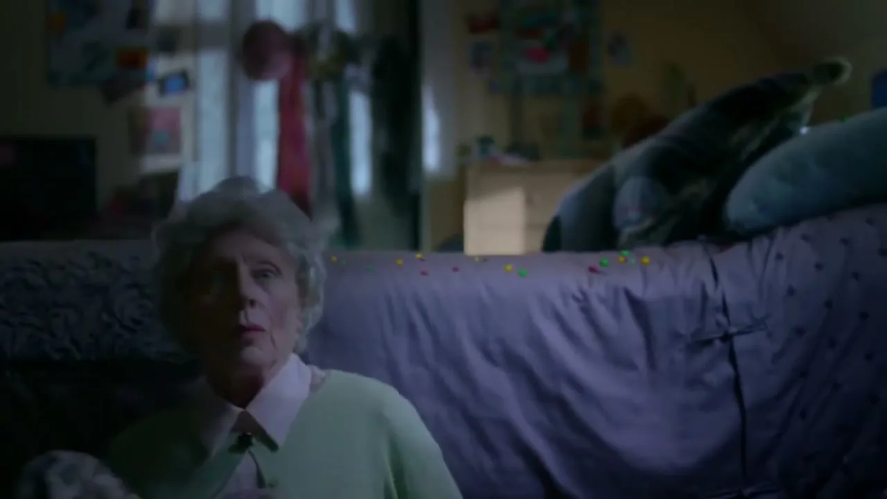 A young woman, an older woman, a middle-aged man, a police officer, and a beaver-like creature appear one by one, catching Skittles in their mouths in a bedroom.