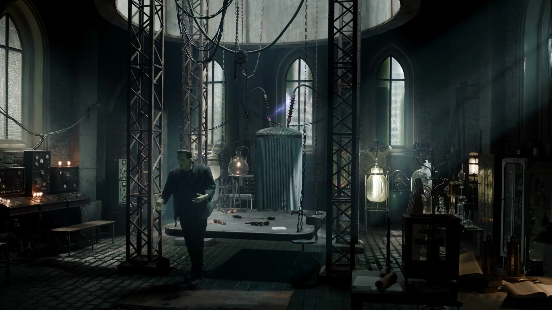 Frankenstein's monster, a green-skinned man in a dark suit, stands in a gothic laboratory as electricity sparks from a large machine.