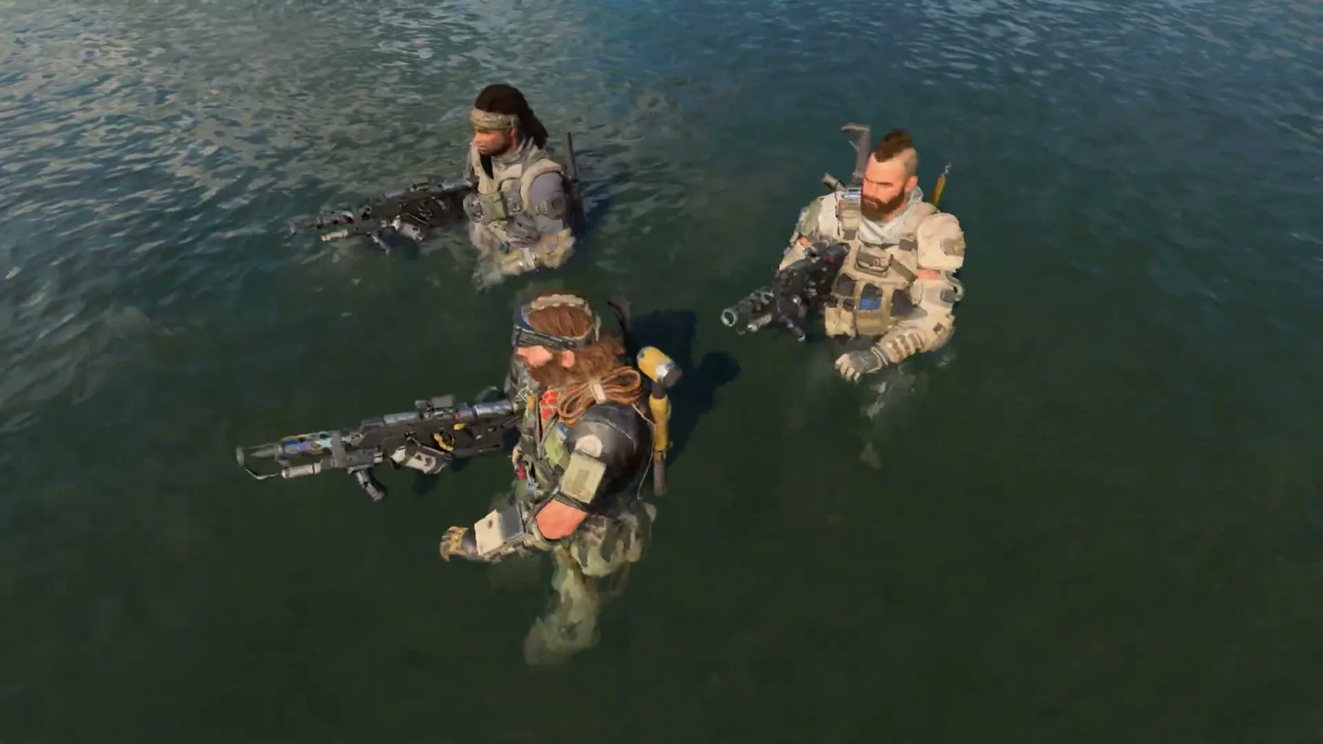 Three male soldiers in tactical gear, holding rifles, stand in shallow water, looking around in a wide shot.