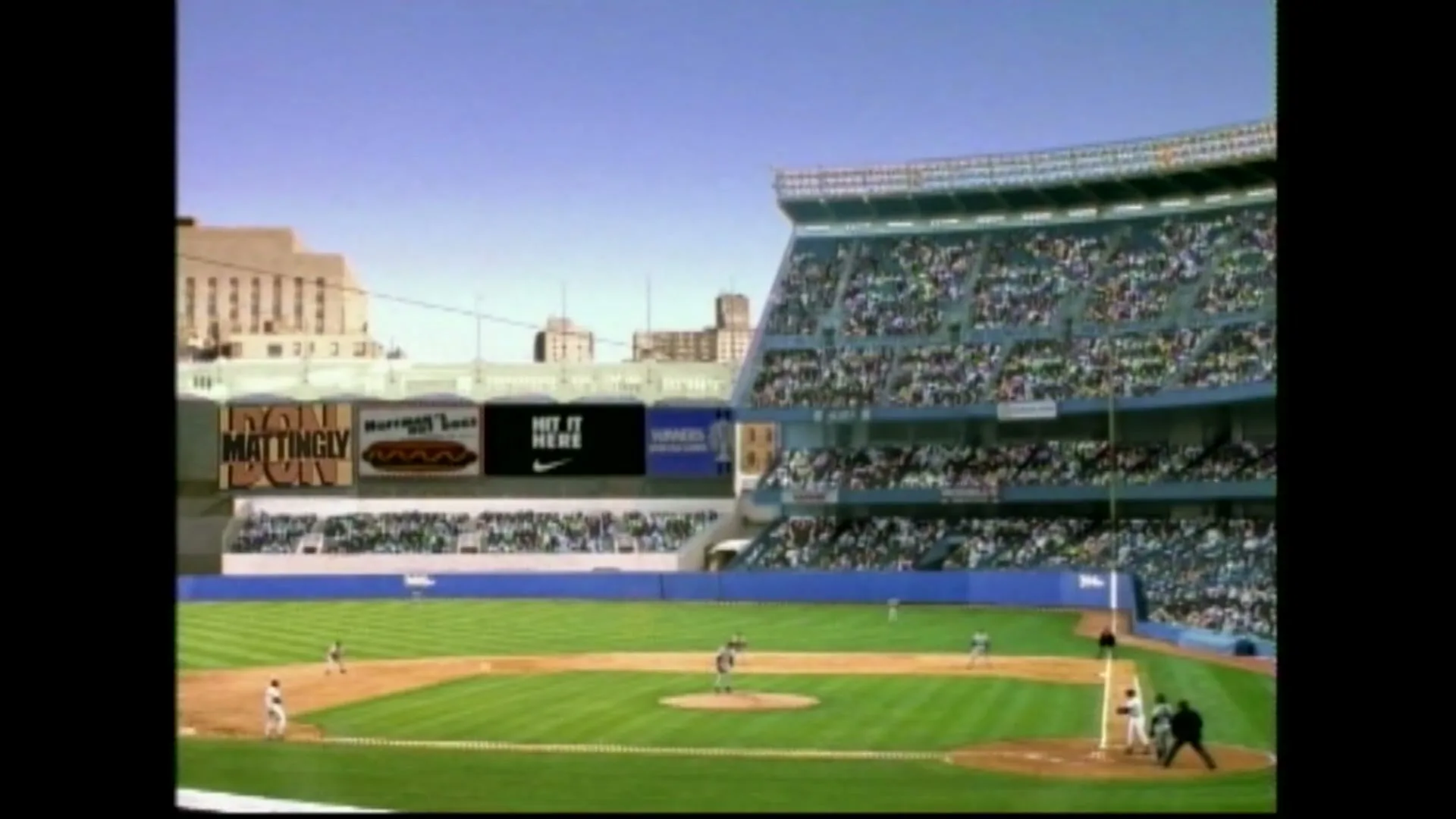 A wide shot of a baseball stadium with players on the field and spectators in the stands under a clear blue sky.