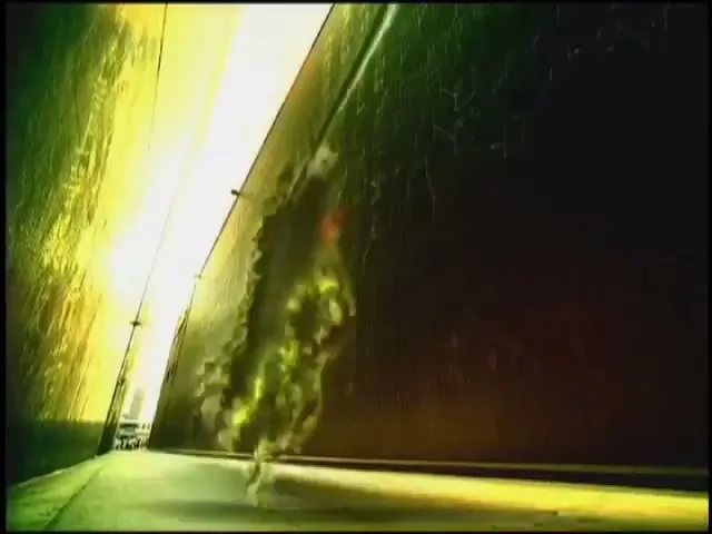 A man's face with a white eye is superimposed over a dark, narrow corridor with bright light at the end.