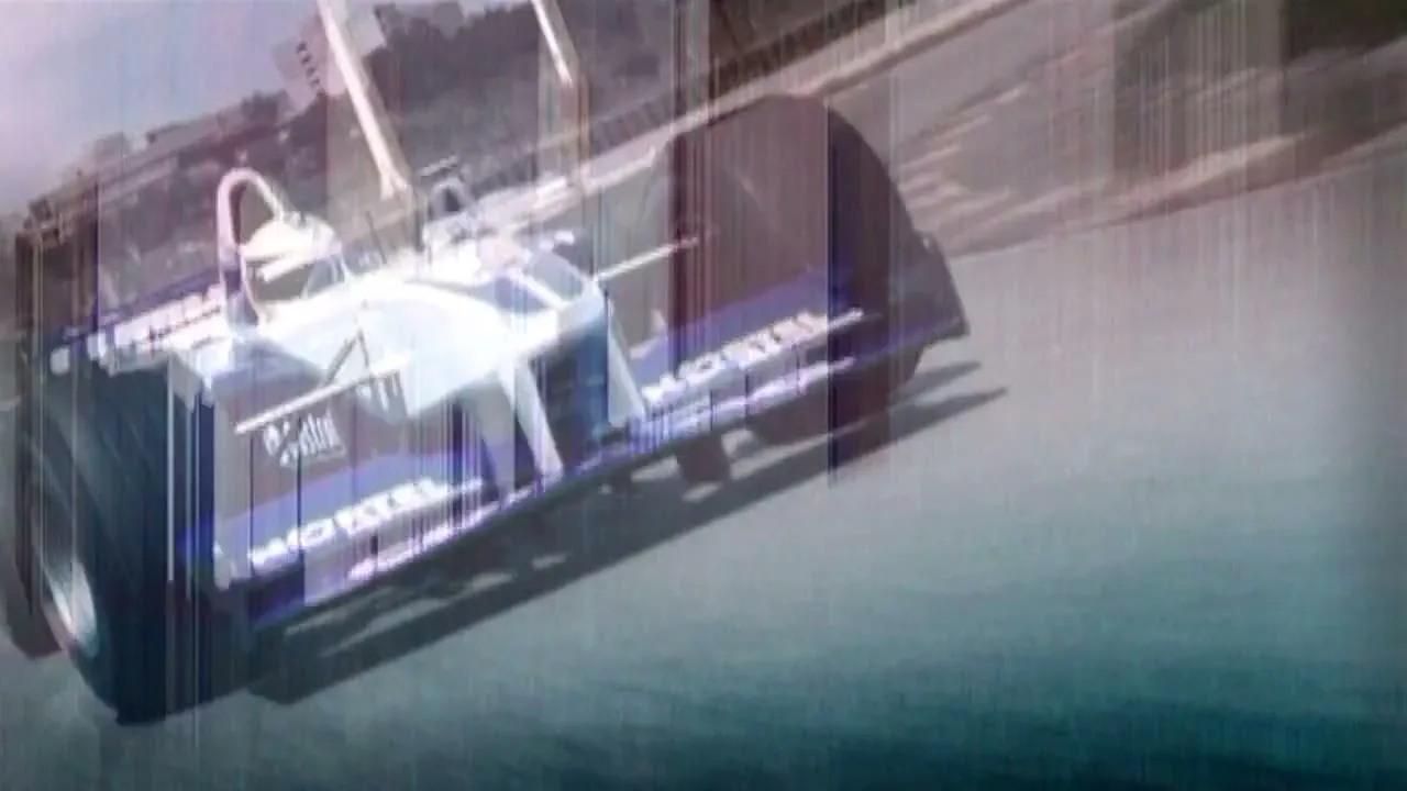 Two Formula 1 race cars, one in the foreground and one in the background, speed around a track during a race.