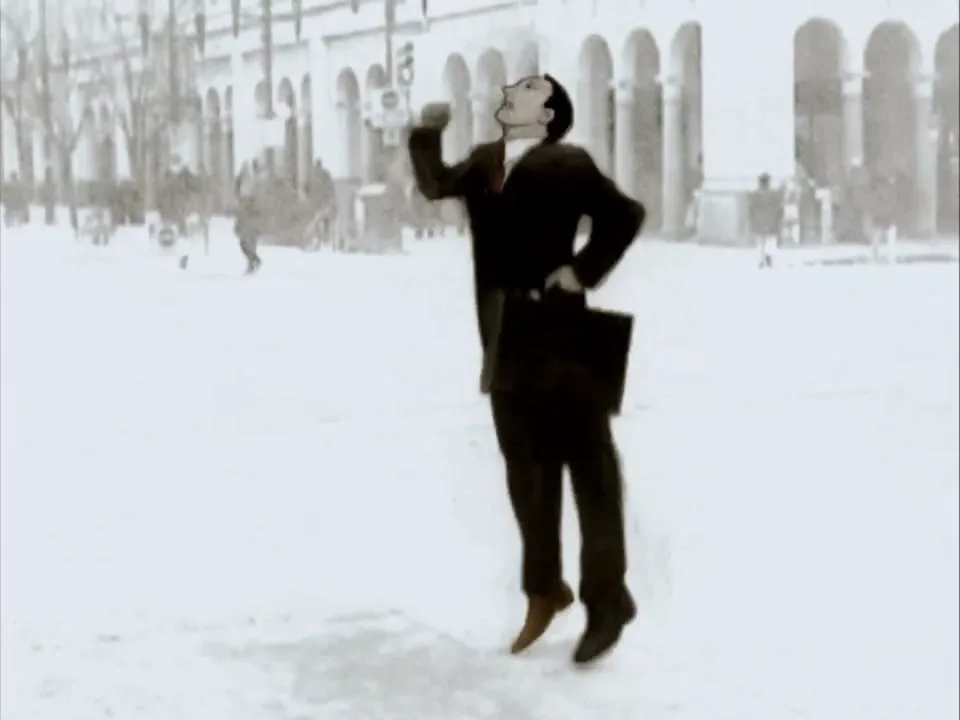 A man in a suit with a briefcase jumps joyfully in a city street, then a United Airlines plane is superimposed over him.
