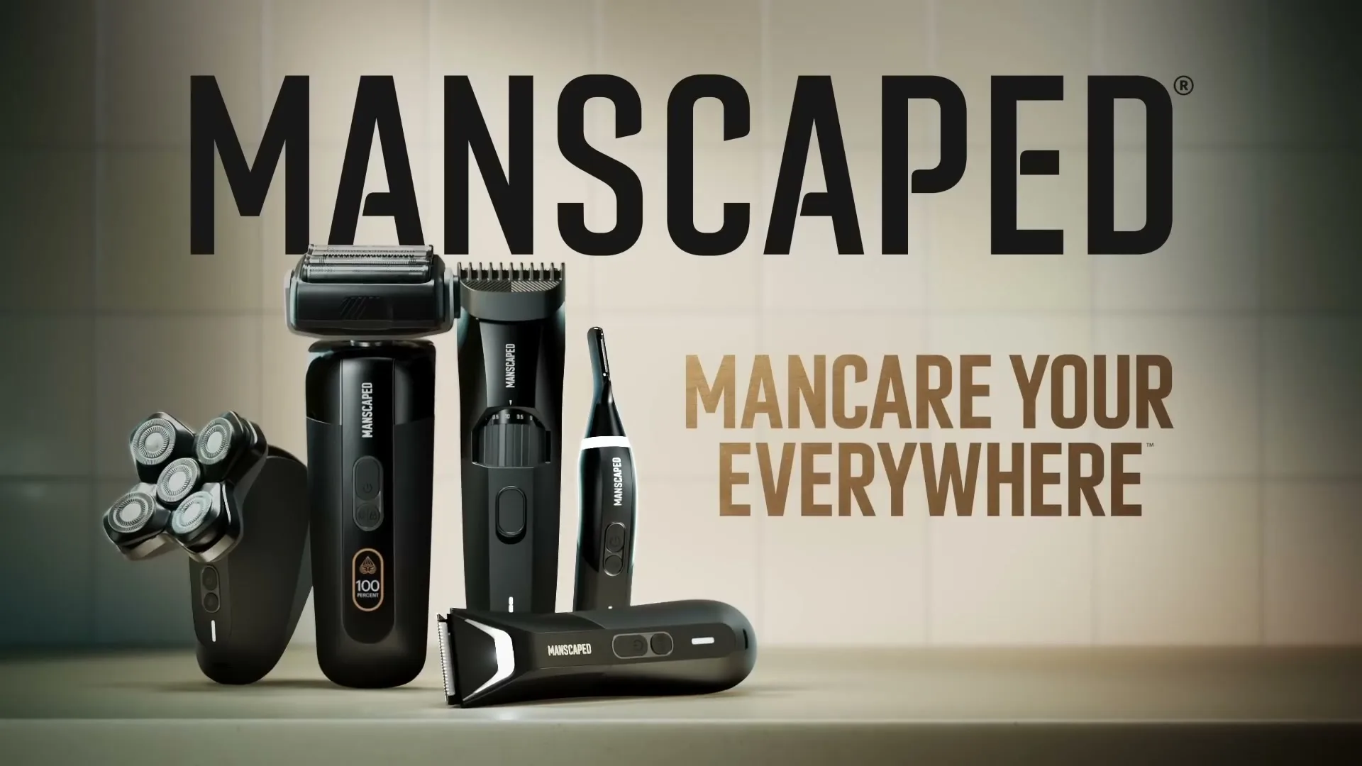 A collection of black Manscaped grooming products are displayed on a bathroom counter with the brand logo and tagline on screen.