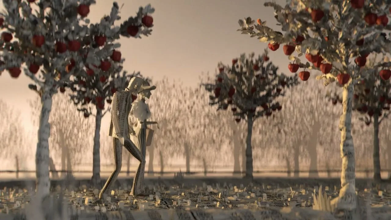 Two paper-made people walk through an orchard of paper trees with red apples, as paper leaves fall and the background darkens.