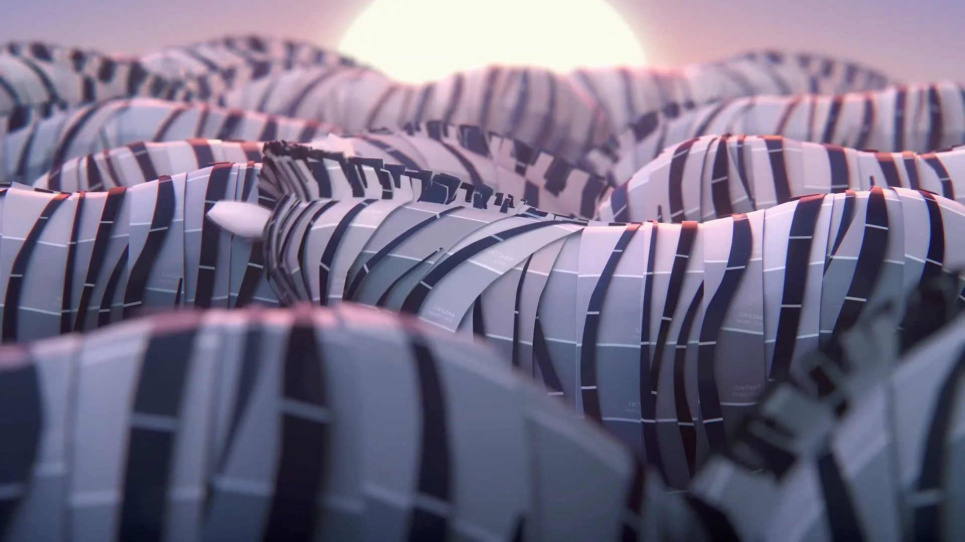 A herd of zebras made of paint swatches are seen from a low angle, with one zebra turning its head to look at the camera as the sun rises in the background.