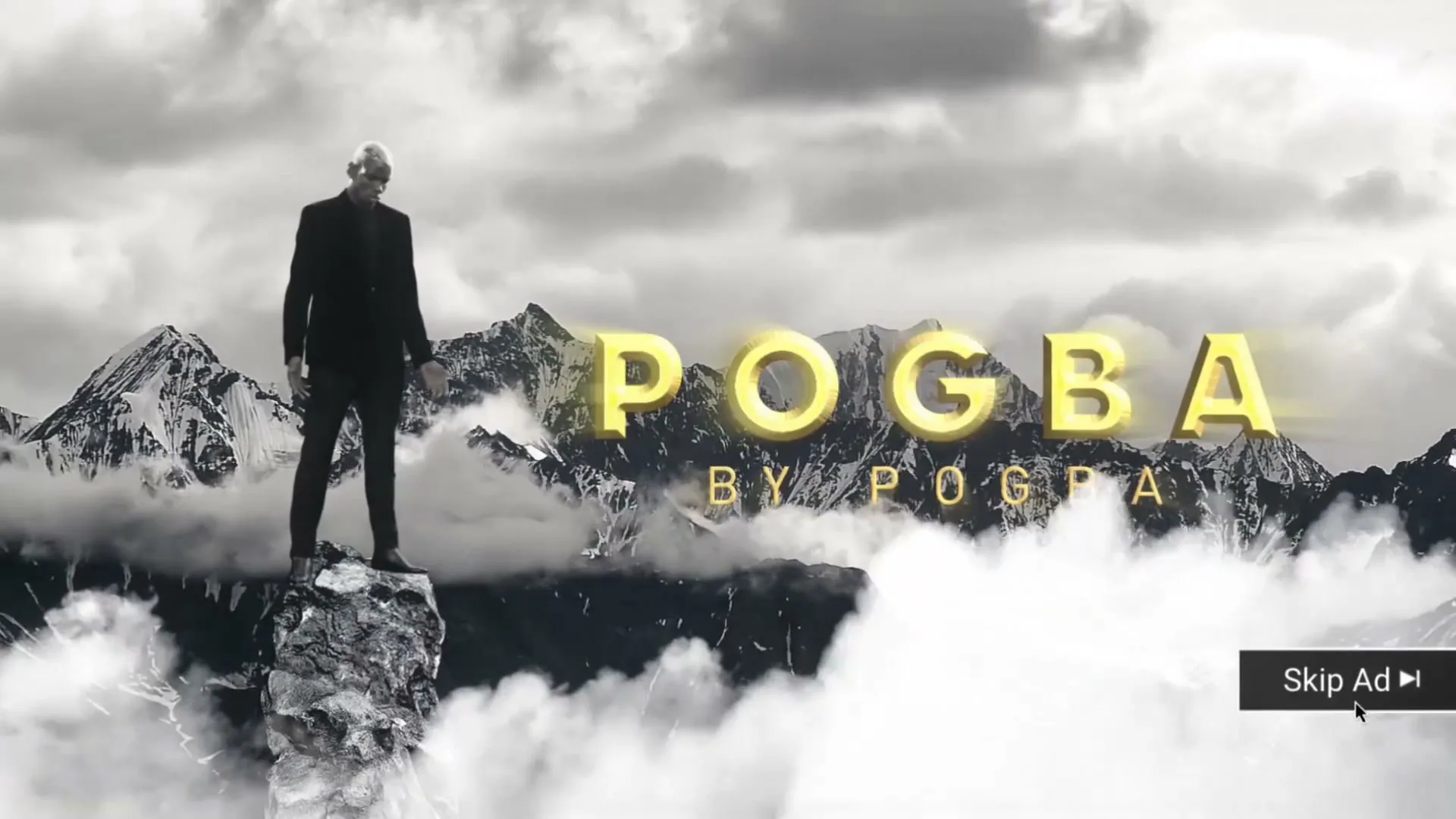 A man in a suit stands on a mountain peak with text "POGBA BY POGBA" in a dramatic, virtual mountain landscape.
