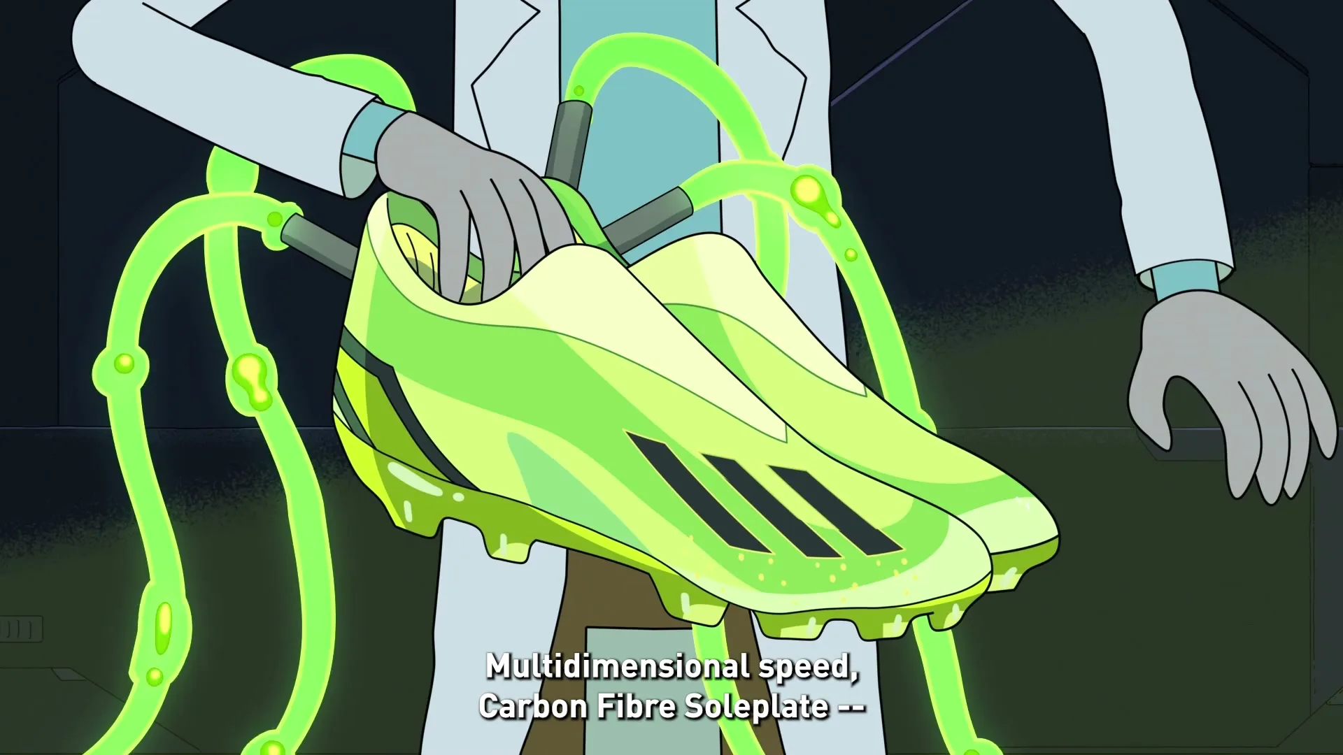 A cartoon scientist in a lab coat holds up a pair of bright green soccer cleats with glowing green tubes attached, in a dark lab.