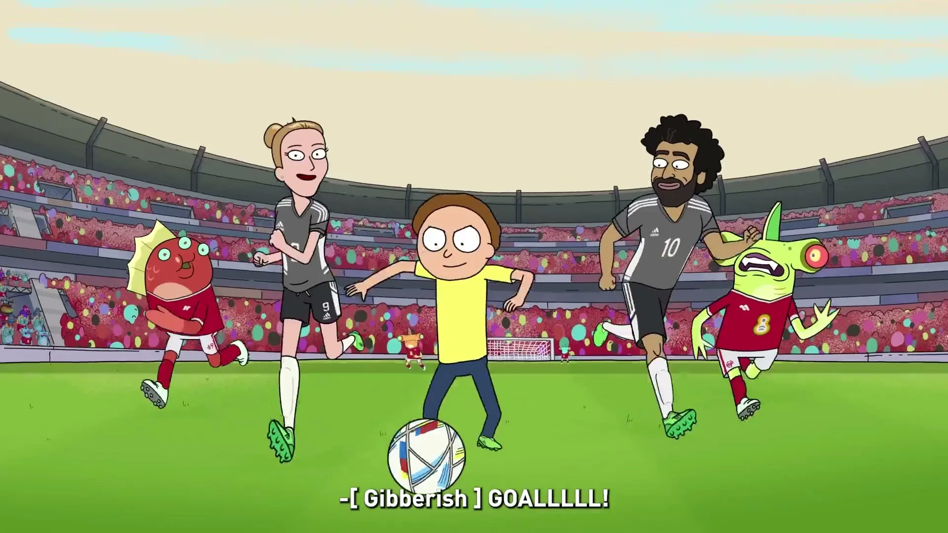 Morty Smith, a young male, dribbles a soccer ball down a field with other players and alien creatures in a stadium.