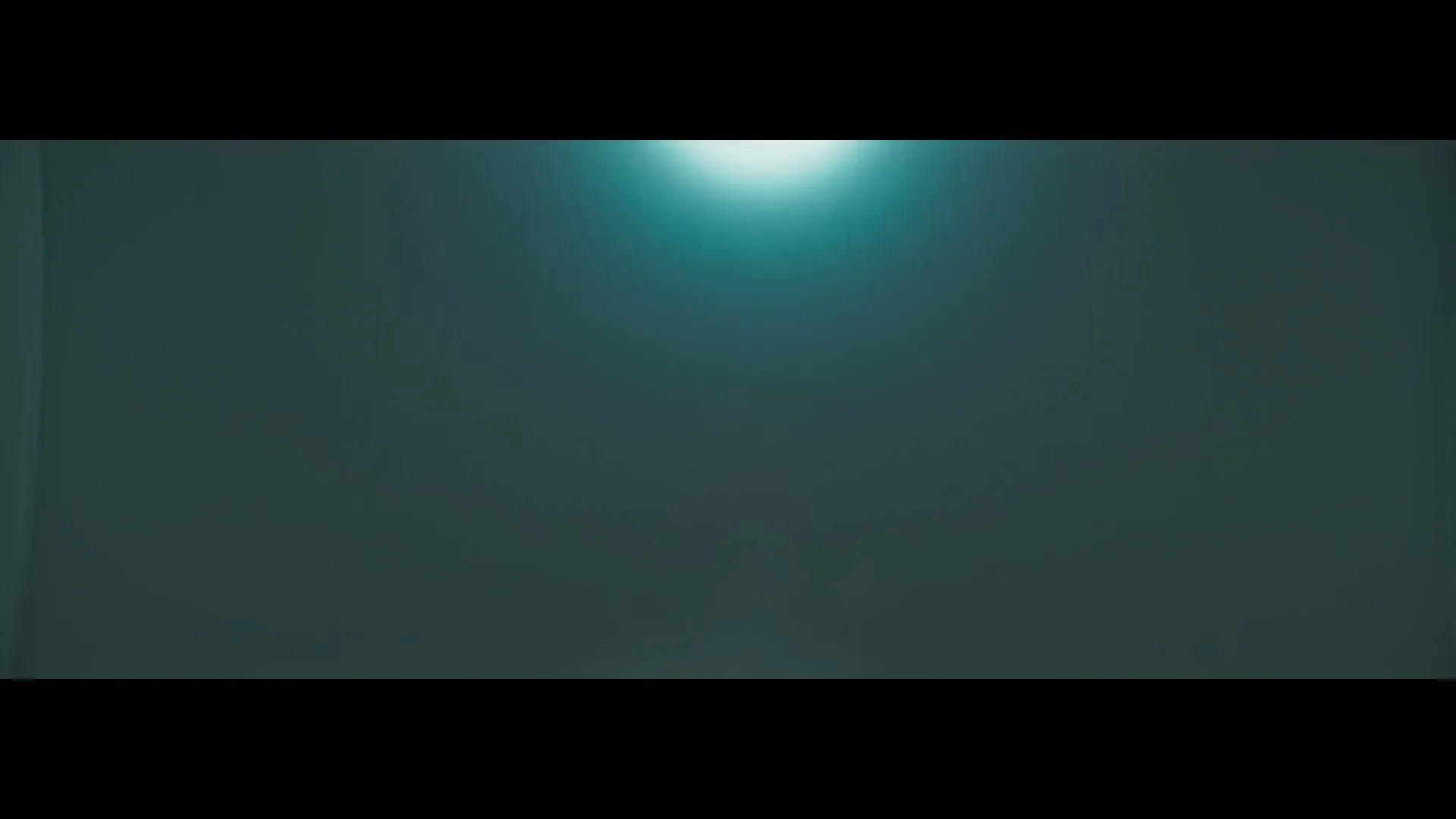 A bright, circular light source at the bottom of the frame expands to fill the entire screen with white light.